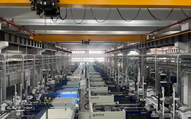 High-capacity injection molding lines connected to overhead utility piping